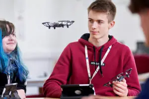 Student flying micro drone in class